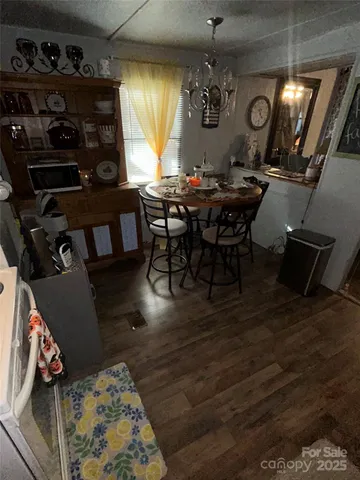 a dining room with furniture and window