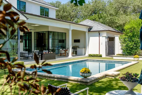 a view of swimming pool with potted plants
