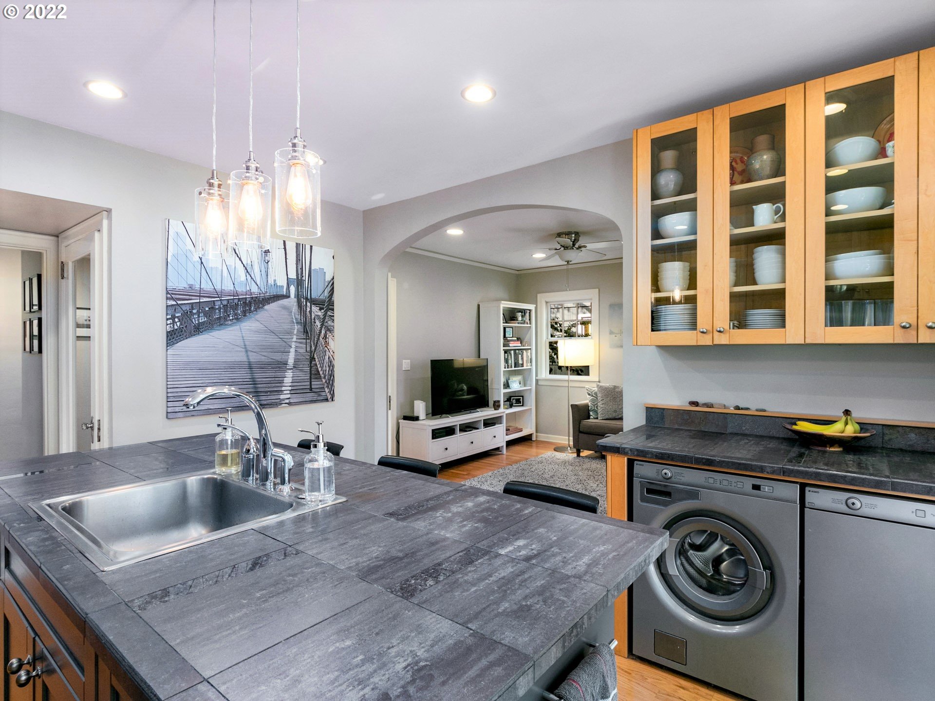 1742 Northeast 60th Avenue Portland, OR 97213 - Photo 12 of 32 a kitchen with granite countertop a sink and a stove top oven with wooden floor
