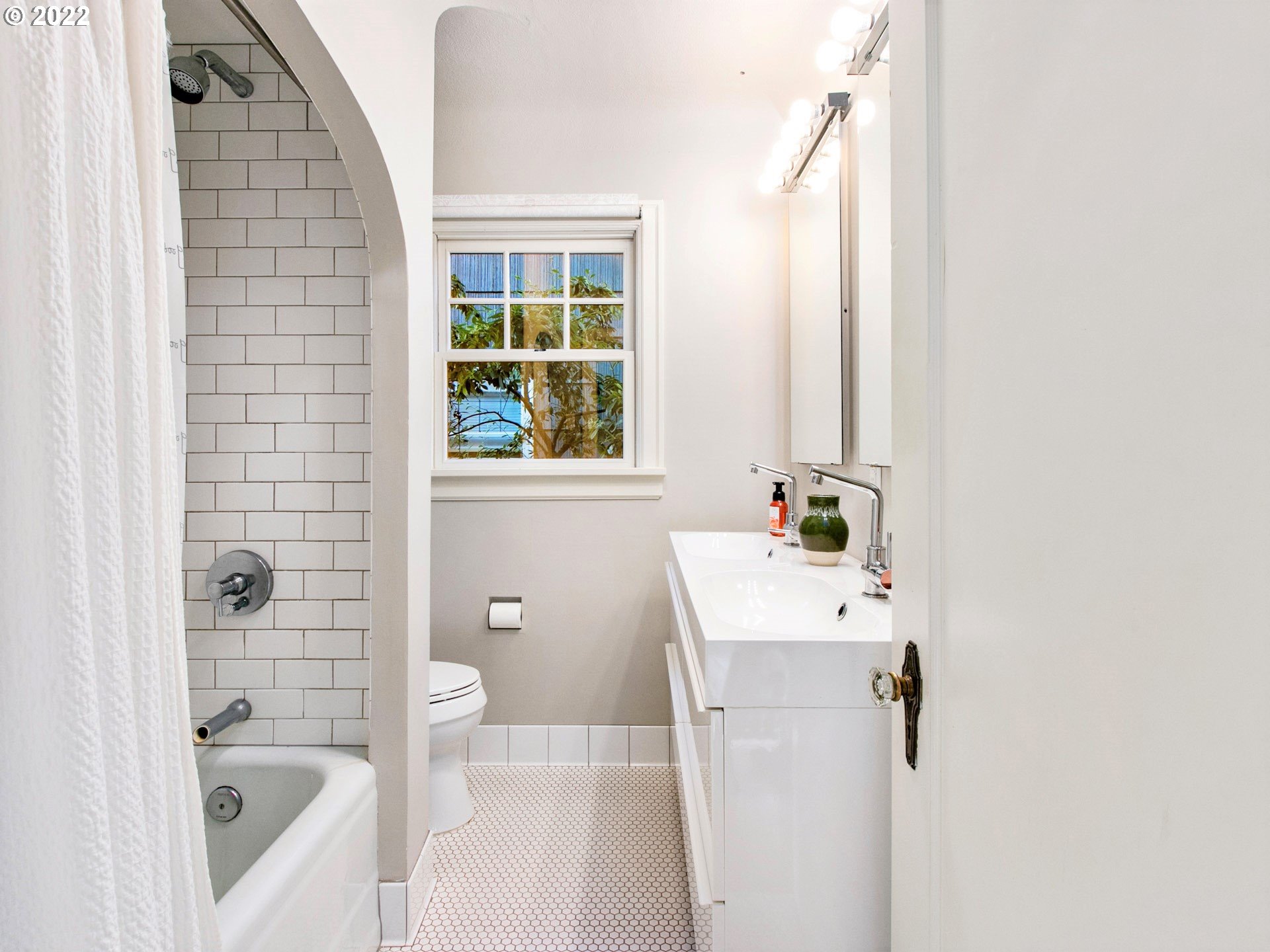 1742 Northeast 60th Avenue Portland, OR 97213 - Photo 14 of 32 a bathroom with a sink a window and shower
