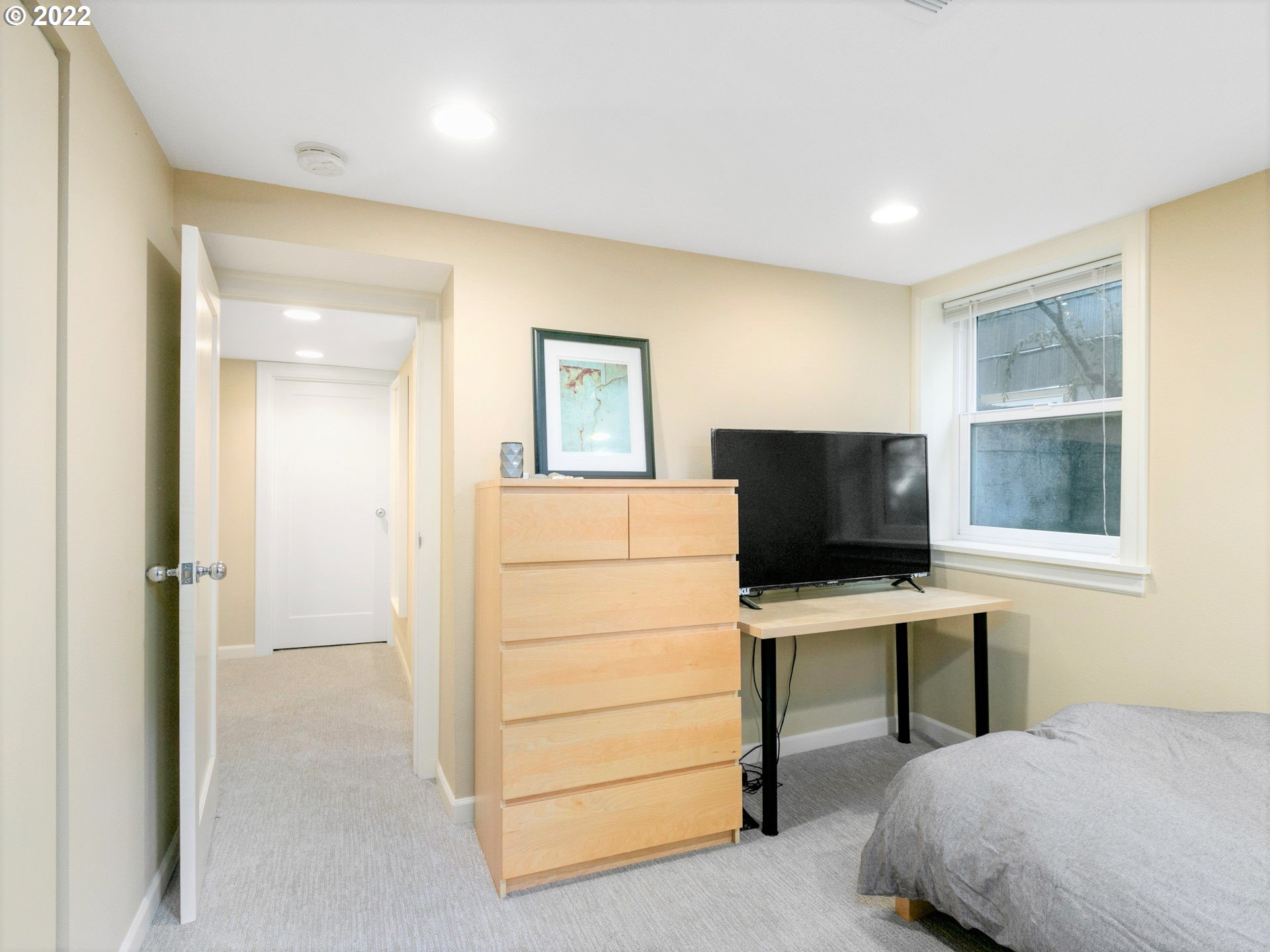 1742 Northeast 60th Avenue Portland, OR 97213 - Photo 26 of 32 a bedroom with a bed and a flat screen tv