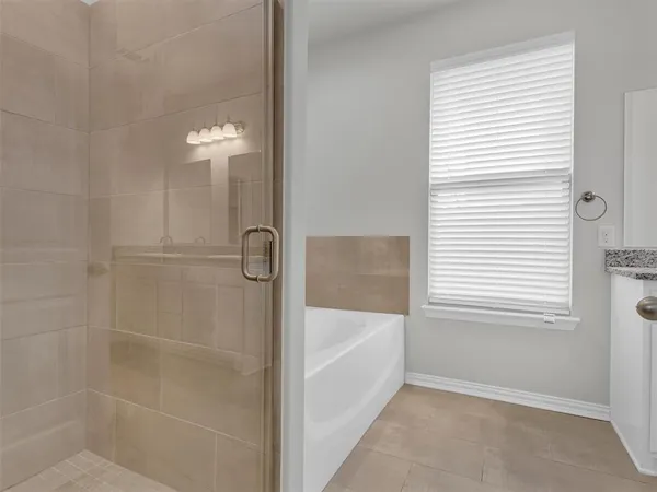 a bathroom with a bathtub and shower