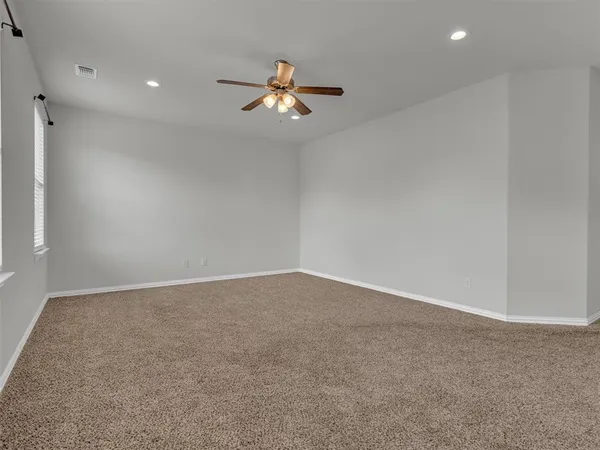 an empty room with a empty space and a ceiling fan