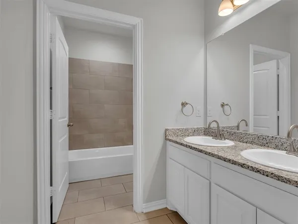 a bath room with a toilet a bath tub and a shower