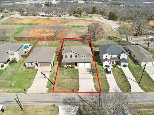 an aerial view of residential houses with outdoor space
