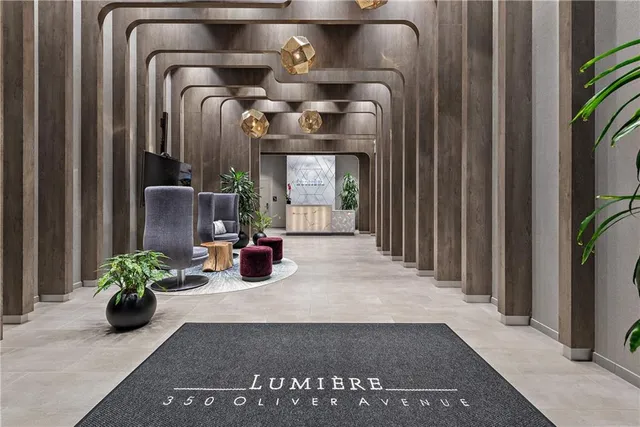 a living room with furniture and potted plants