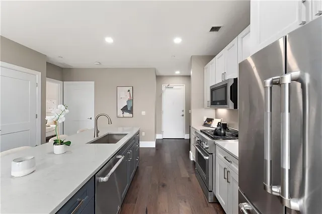 a living room with furniture floor to ceiling window and wooden floor