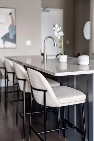 a kitchen with white cabinets and black appliances