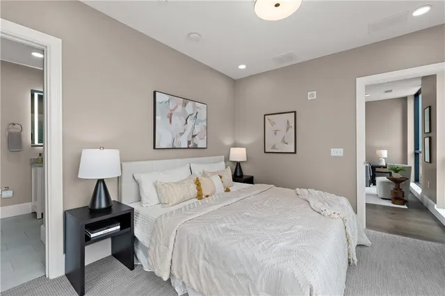 a spacious bedroom with a bed and a chandelier