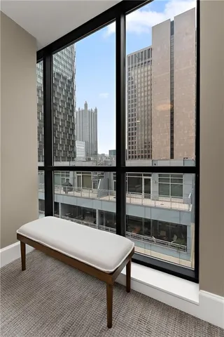 a bathroom with a granite countertop sink two mirror and shower