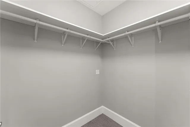 a bedroom with a large bed and a potted plant