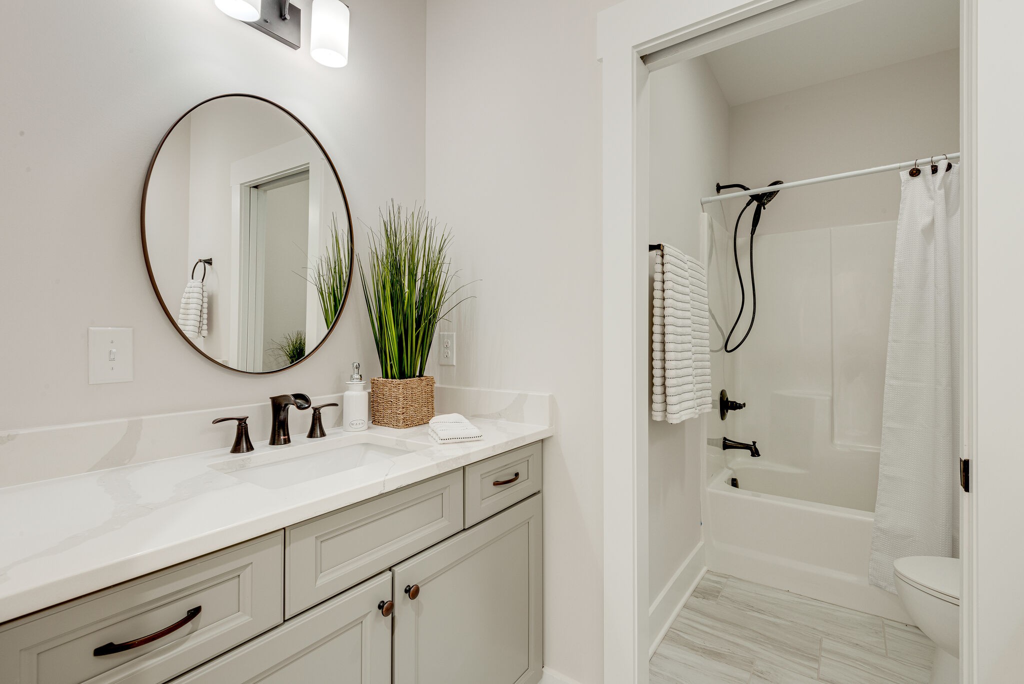 204 Stephen Street Dickson, TN 37055 - Photo 24 of 29 a bathroom with a sink a glass door shower and a mirror