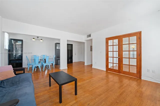 a dining room with furniture and wooden floor