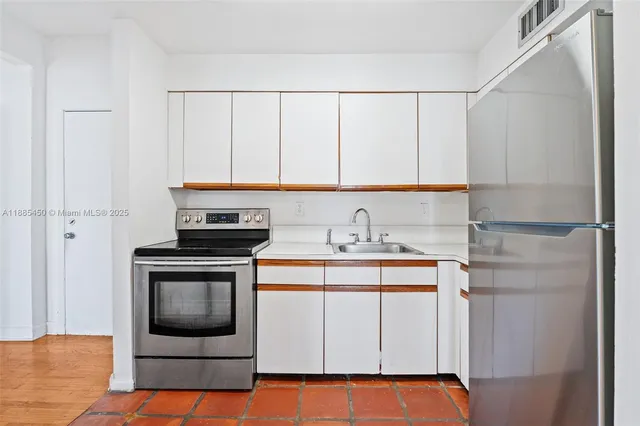 a kitchen with stainless steel appliances a refrigerator and a sink
