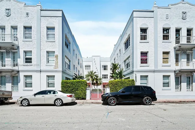 a view of a building with a garden and pathway