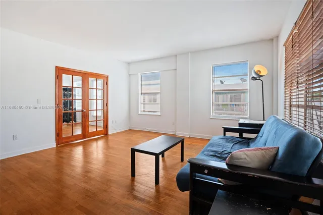 a living room with furniture and a flat screen tv with wooden floor