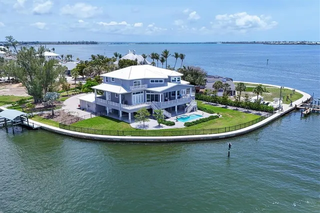 a view of a swimming pool with lawn chairs under an umbrella
