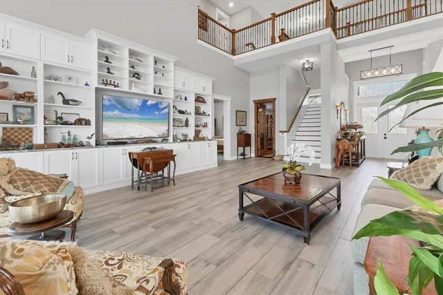 a living room with lots of furniture and kitchen view
