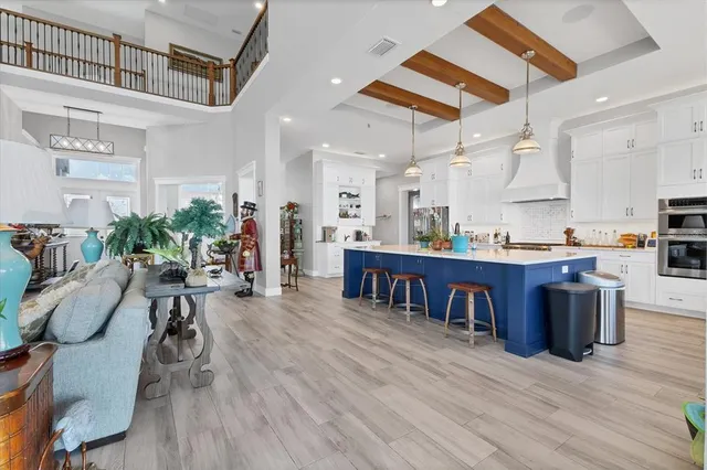 a kitchen with stainless steel appliances a stove a sink and a wooden floors