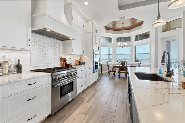 a hall with cabinets and wooden floor