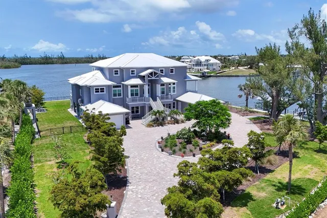 an aerial view of a house with a garden and lake view