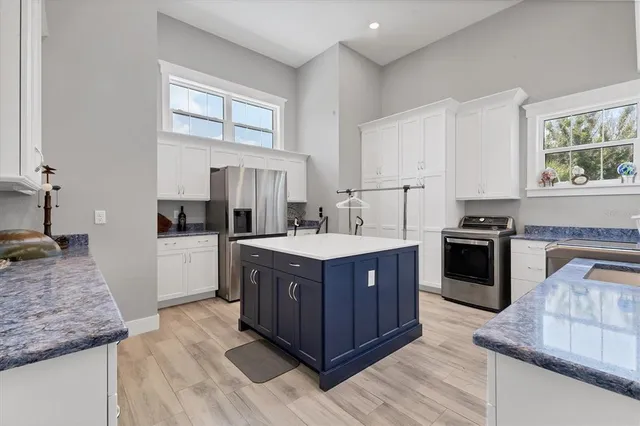 a dining room with furniture water view and a floor to ceiling window