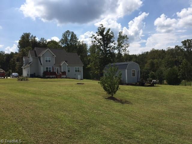 Expansive back yard. Septic field and repair is behind and high to the right, top of property. (see plat)