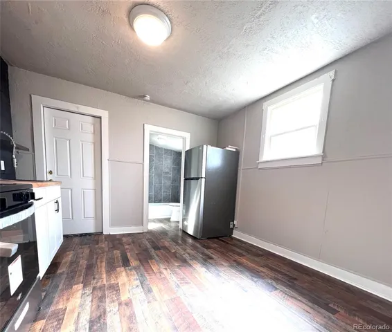 a view of a room with wooden floor and staircase