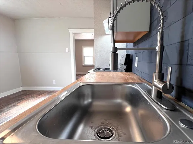 a kitchen with stainless steel appliances kitchen island granite countertop a refrigerator stove and sink