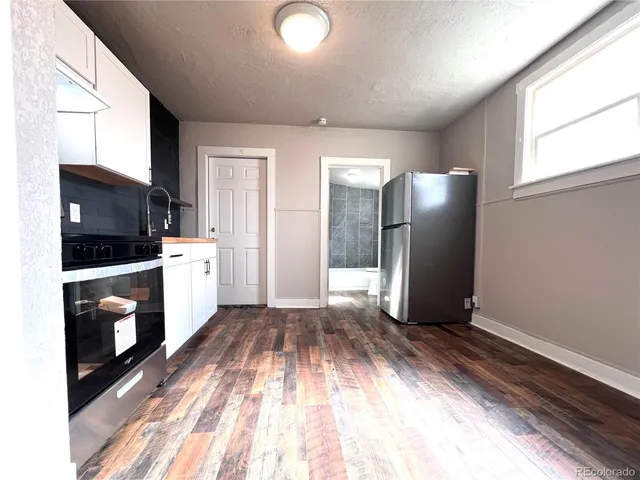 a living room with a flat screen tv and a floor to ceiling window
