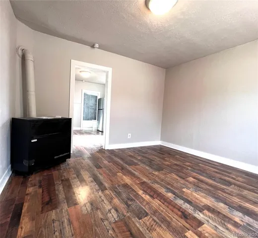 a view of an empty room and wooden floor
