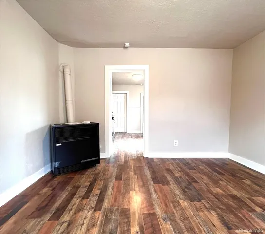 a view of an empty room and wooden floor