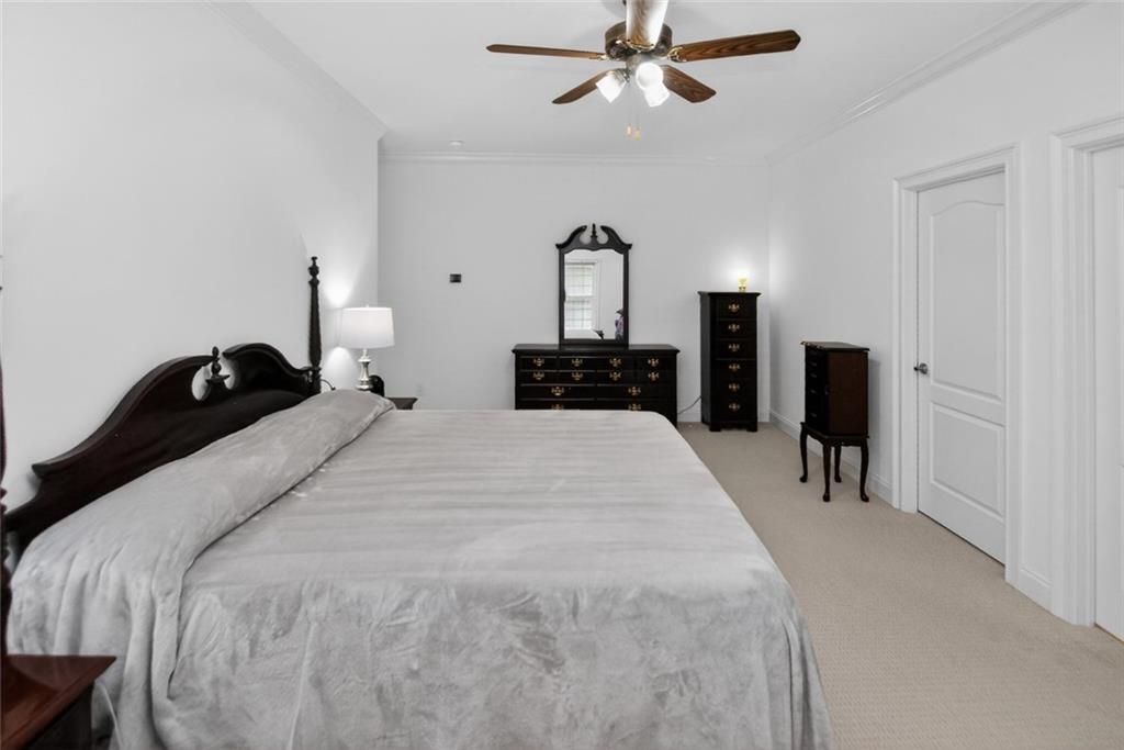 4113 Ledan Extension Gainesville, GA 30506 - Photo 108 of 195 a bedroom with a bed and a chandelier