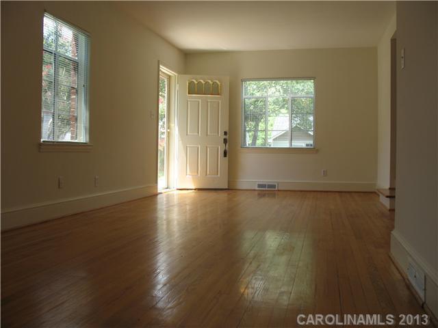 1634 Club Road Charlotte, NC 28205 - Photo 3 of 8 an empty room with wooden floor and windows