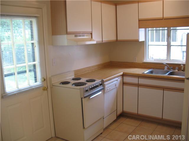 1634 Club Road Charlotte, NC 28205 - Photo 6 of 8 a kitchen with granite countertop a sink a stove and cabinets