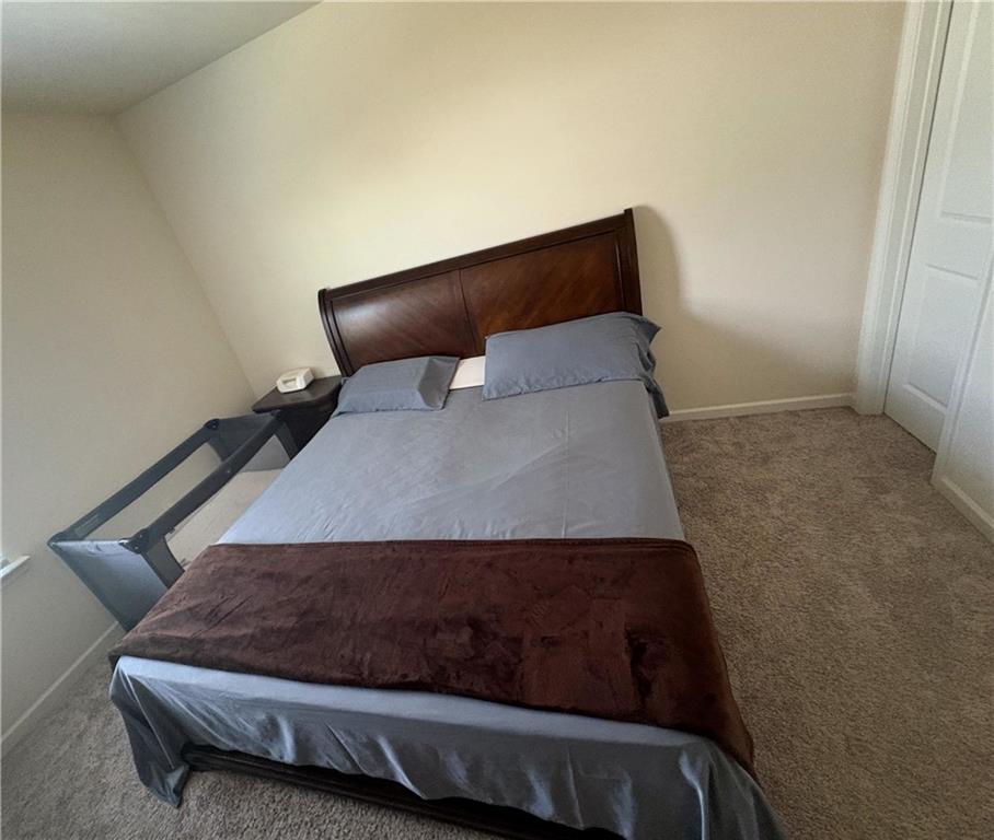 3424 Pratt Way Bethlehem, GA 30620 - Photo 17 of 23 a bed sitting in a bedroom next to a window