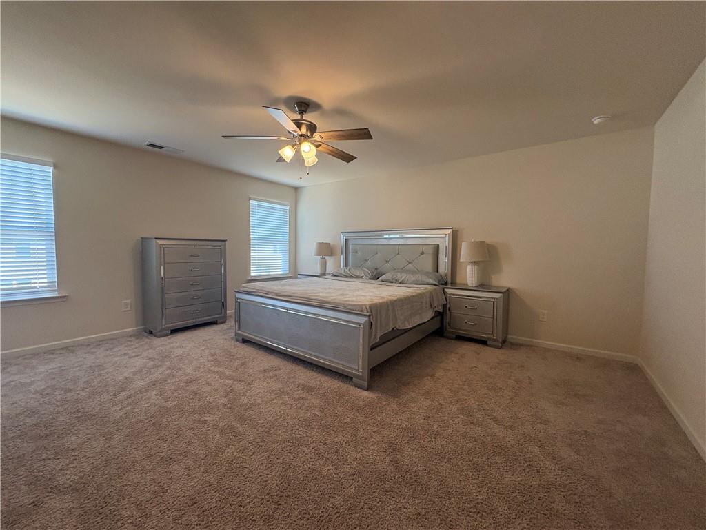 3424 Pratt Way Bethlehem, GA 30620 - Photo 20 of 23 a white bed sitting in a bedroom and chandelier