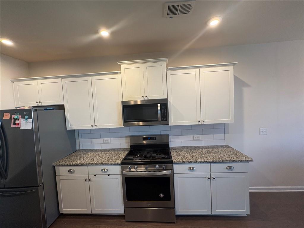 3424 Pratt Way Bethlehem, GA 30620 - Photo 7 of 23 a kitchen with granite countertop white cabinets and stainless steel appliances