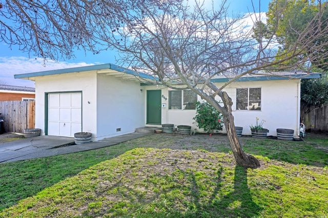a backyard of a house with yard and outdoor seating