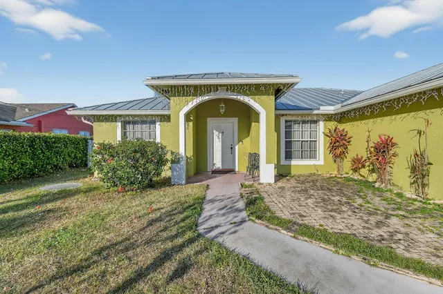 a view of front door and small yard
