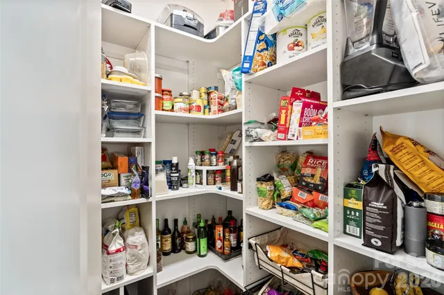 a living room with furniture a flat screen tv and a window