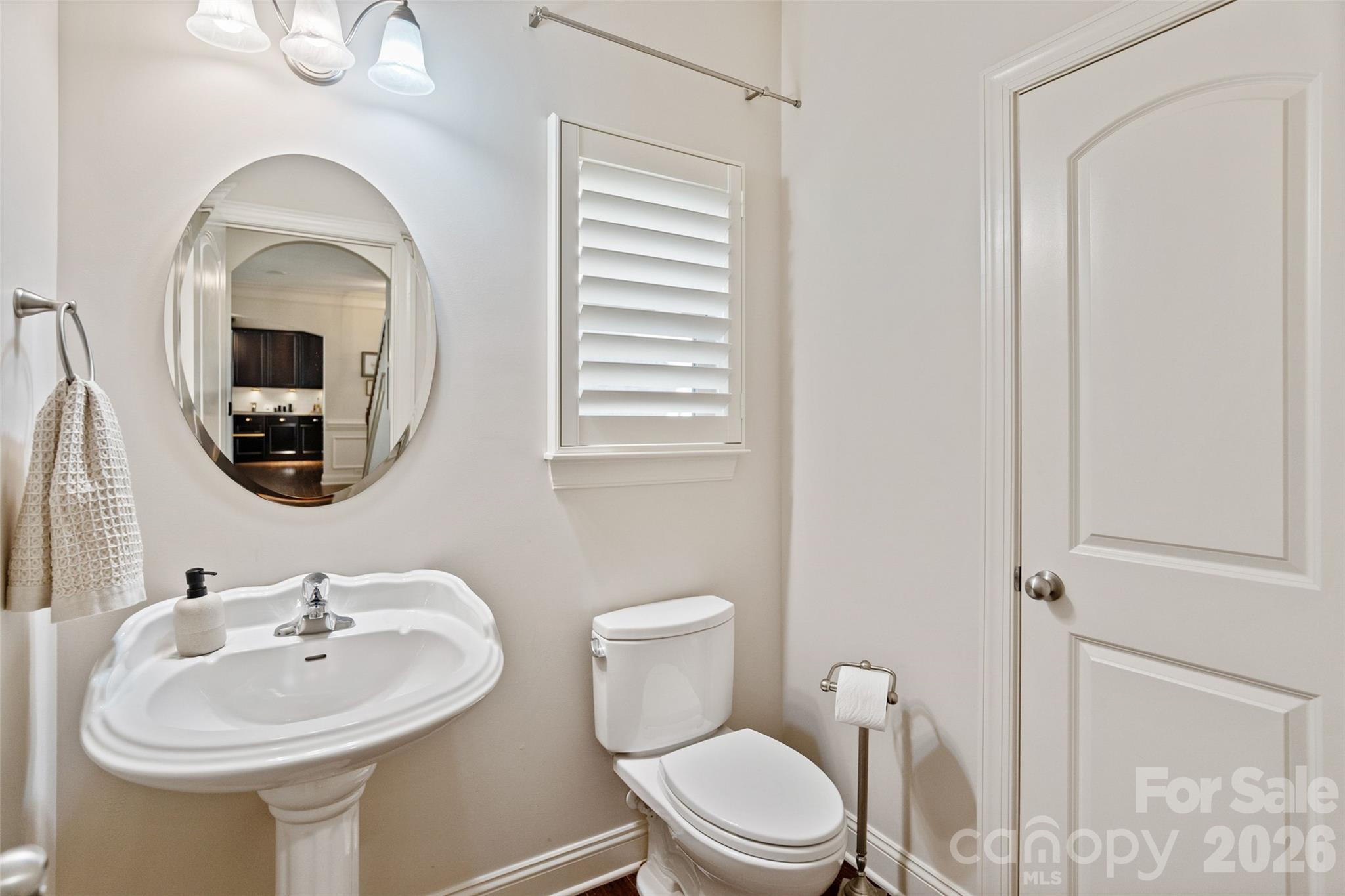 9104 Blue Ridge Drive Indian Land, SC 29707 - Photo 18 of 41 a bathroom with a toilet a sink and a mirror