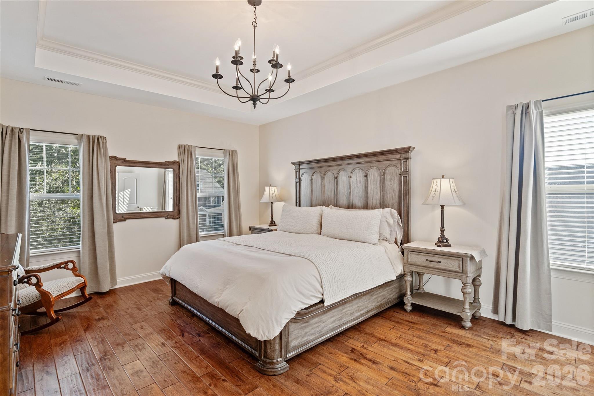 9104 Blue Ridge Drive Indian Land, SC 29707 - Photo 20 of 41 a bedroom with a bed chandelier and a window