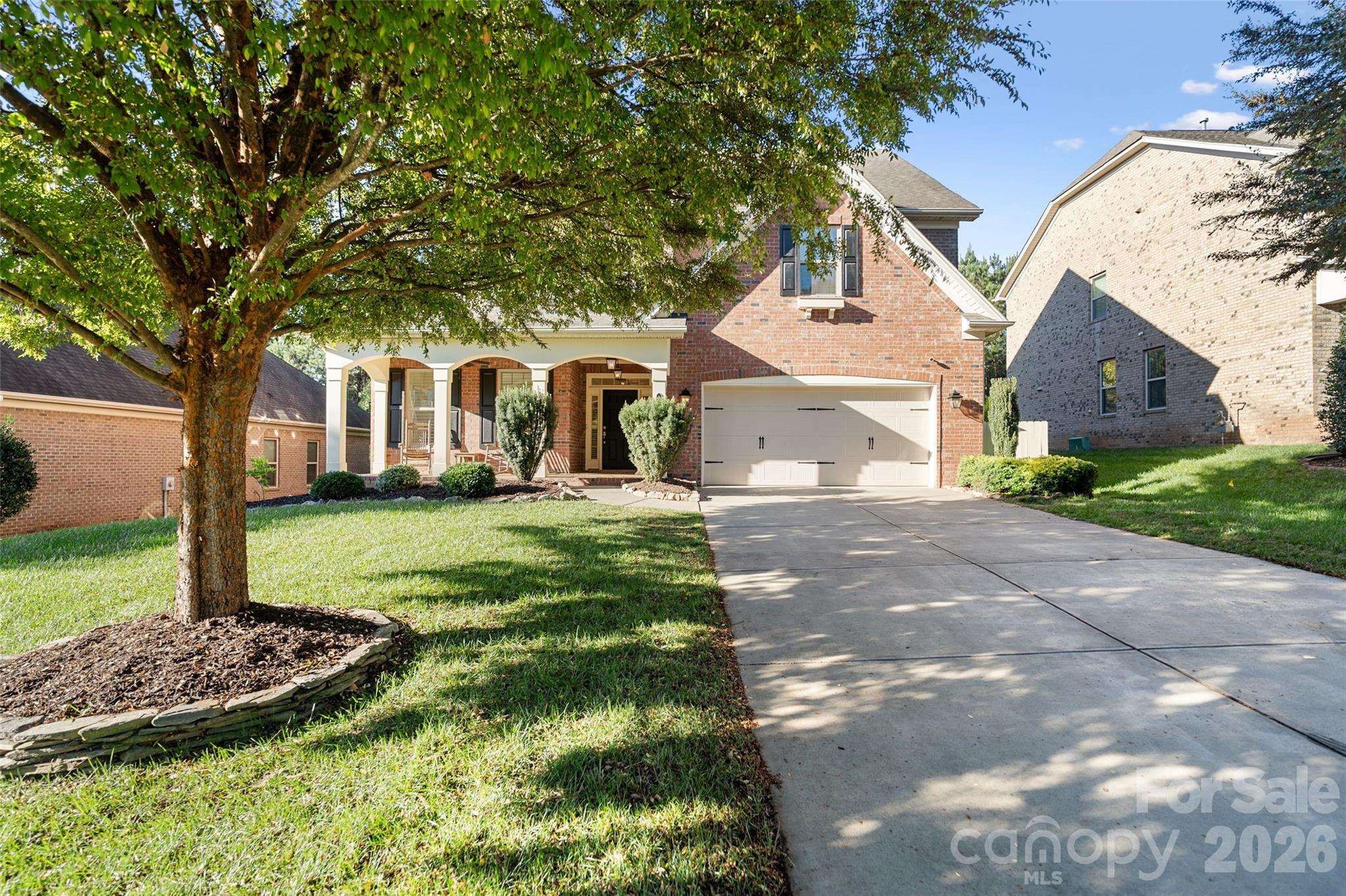 9104 Blue Ridge Drive Indian Land, SC 29707 - Photo 2 of 41 a front view of a house with a yard and trees