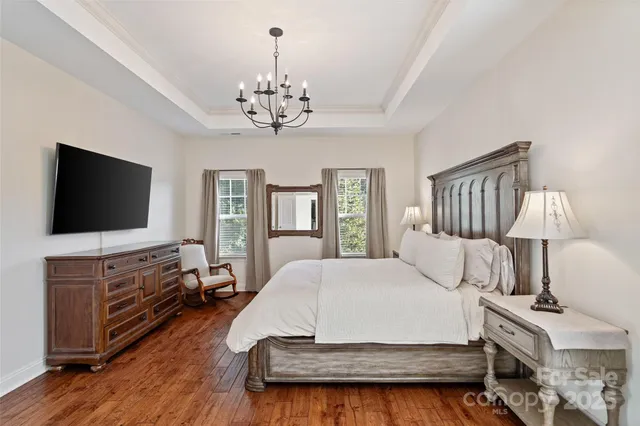 a bathroom with a granite countertop sink a large mirror and shower