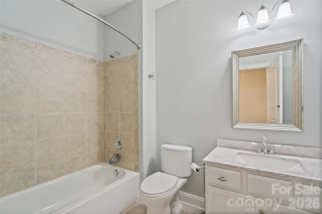 a kitchen with white cabinets and sink