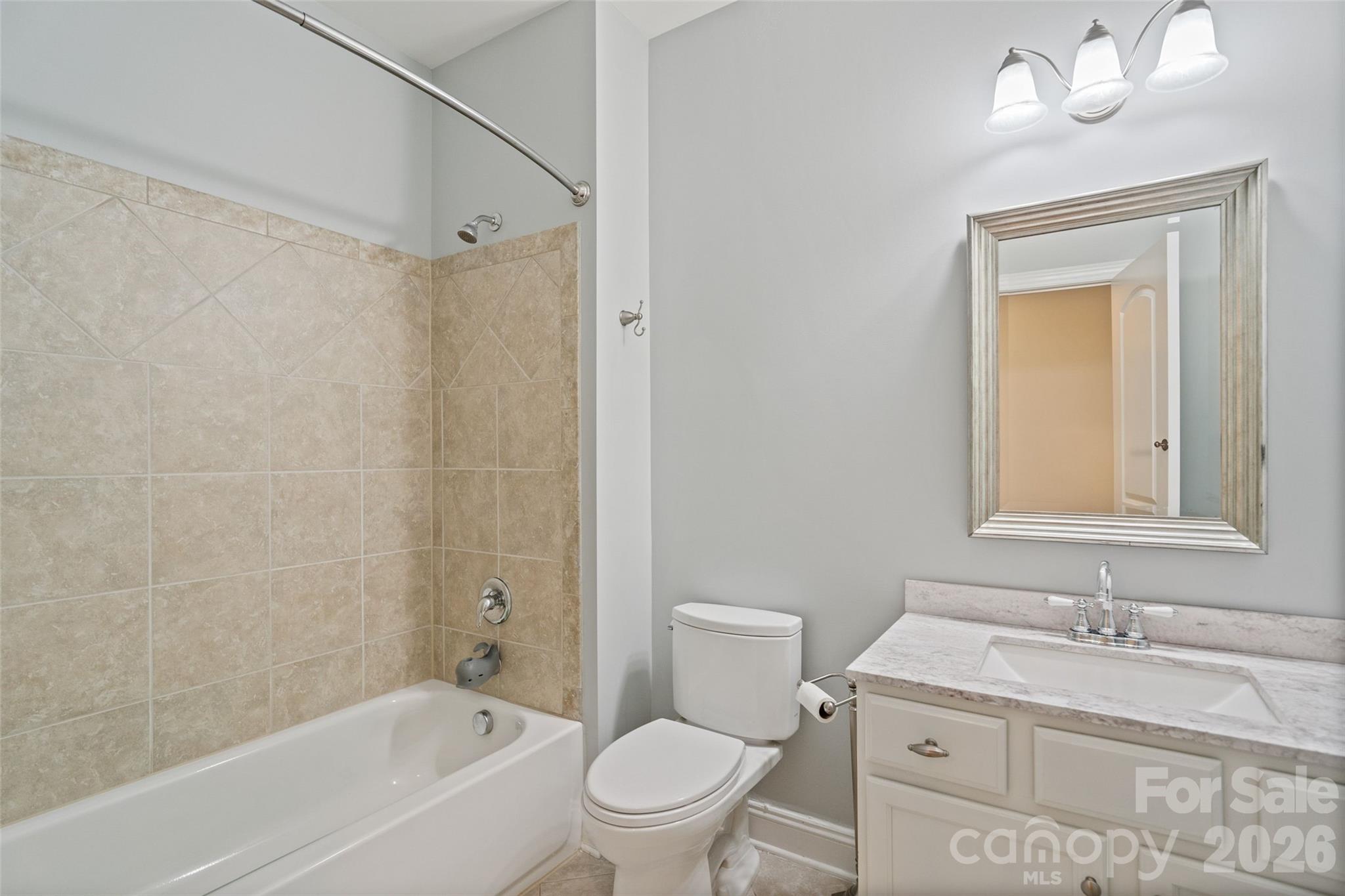 9104 Blue Ridge Drive Indian Land, SC 29707 - Photo 29 of 41 a bathroom with a granite countertop sink a toilet and shower