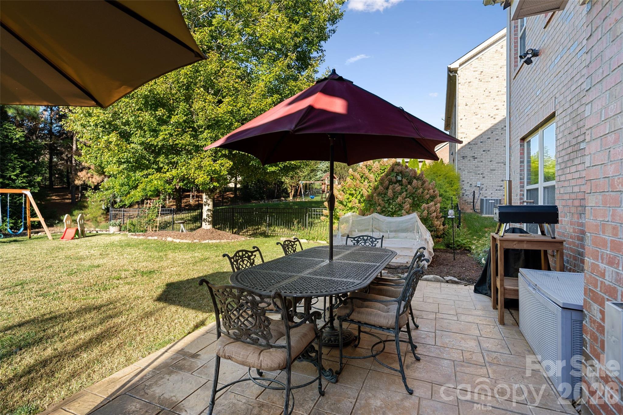 9104 Blue Ridge Drive Indian Land, SC 29707 - Photo 34 of 41 a view of a table and chairs under an umbrella