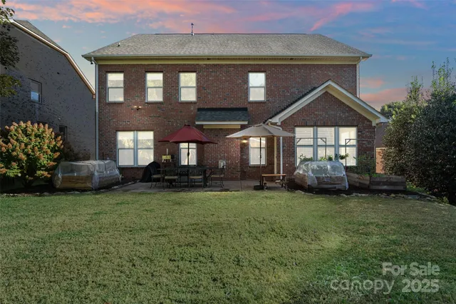 an aerial view of a house with garden space and a swimming pool