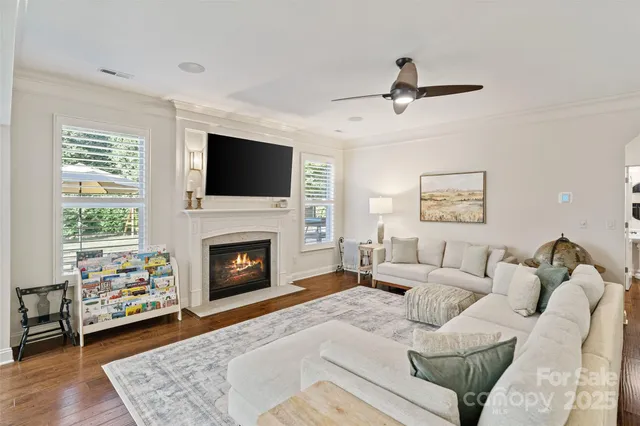 a living room with furniture a fireplace and a flat screen tv